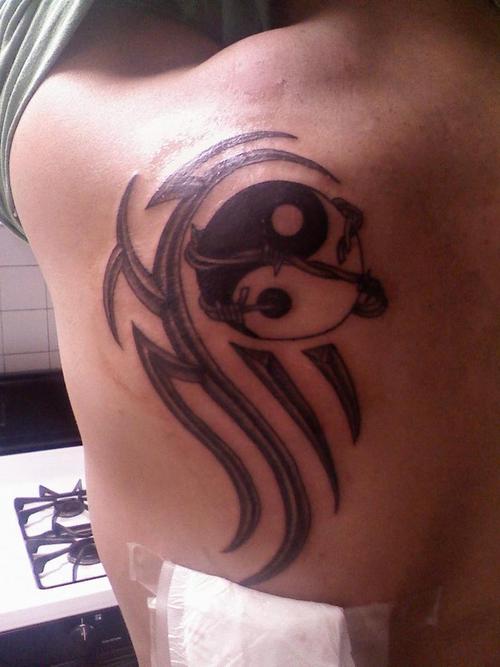 Tribal yin yang tattoo design on back left shoulder